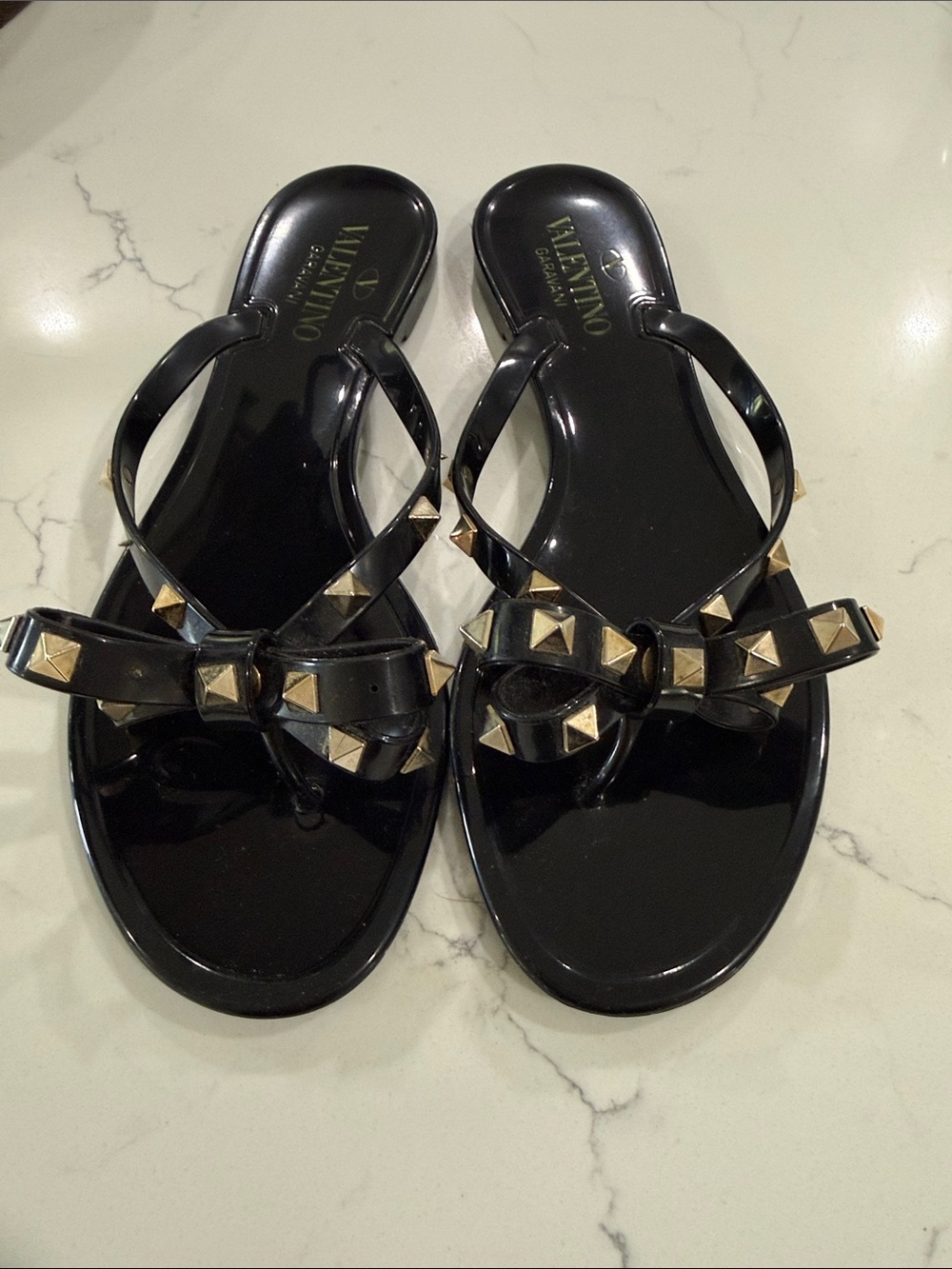 Valentino Black Jelly Thong Sandals with Gold Rockstud Bow